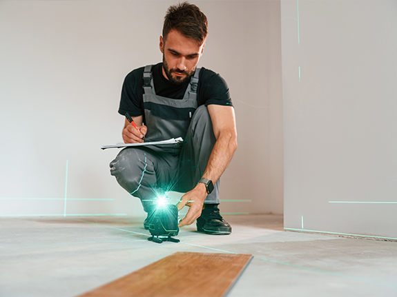 man using a laser level without a tripod