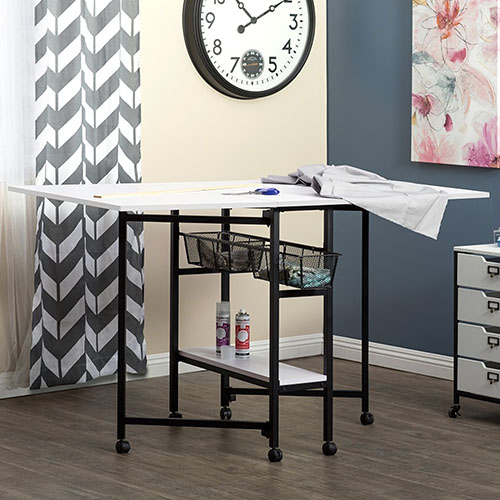 Photograph of  Studio Designs Sew Ready 36&quot; Tall Standing Height Mobile Craft Cutting Table with Storage Baskets Shelf and Expandable Top - Charcoal/White - 13378 